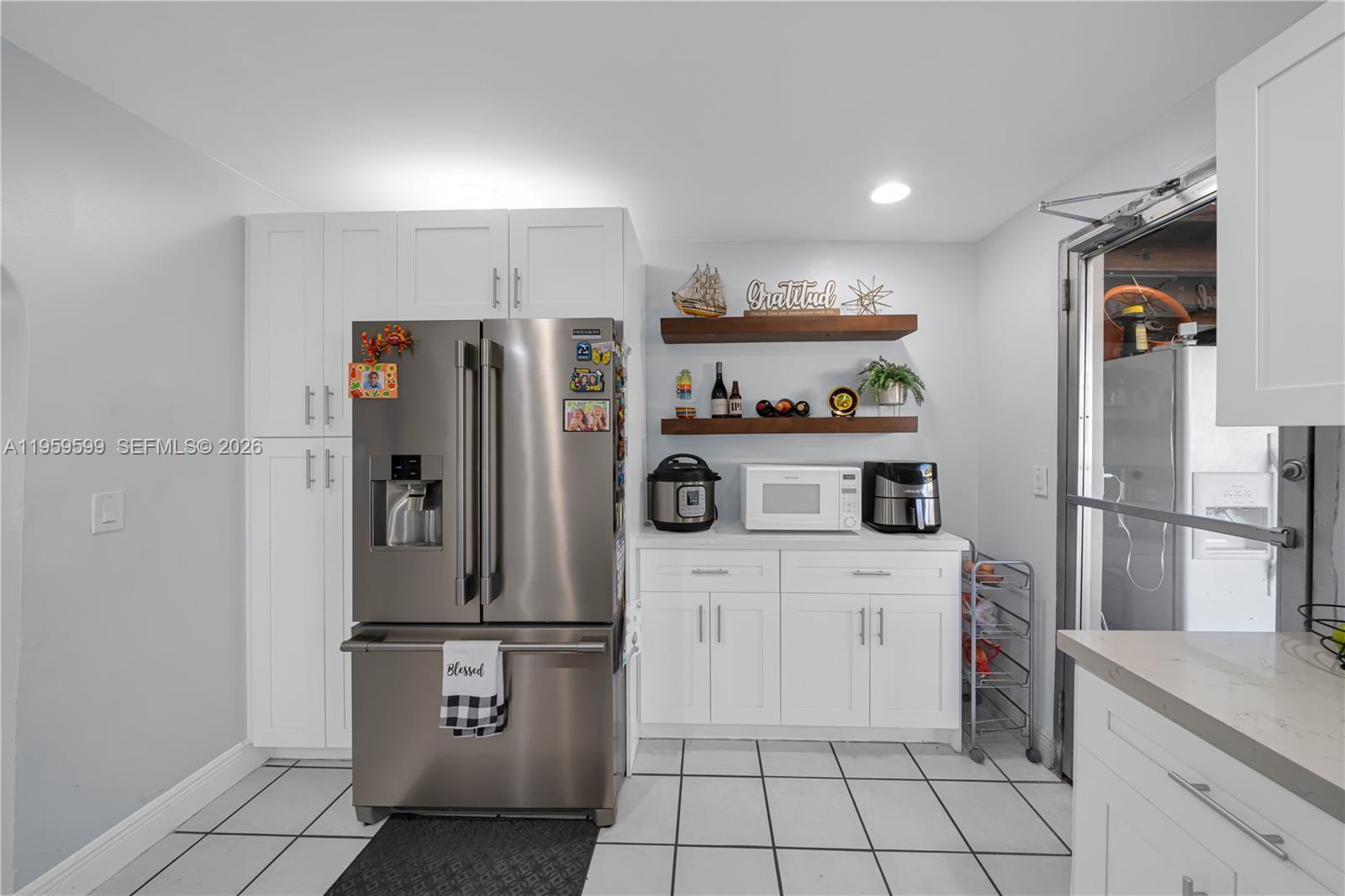 11021 Southwest 4th Street Sweetwater, FL 33174 - Photo 11 of 43 a kitchen with stainless steel appliances a refrigerator sink and cabinets