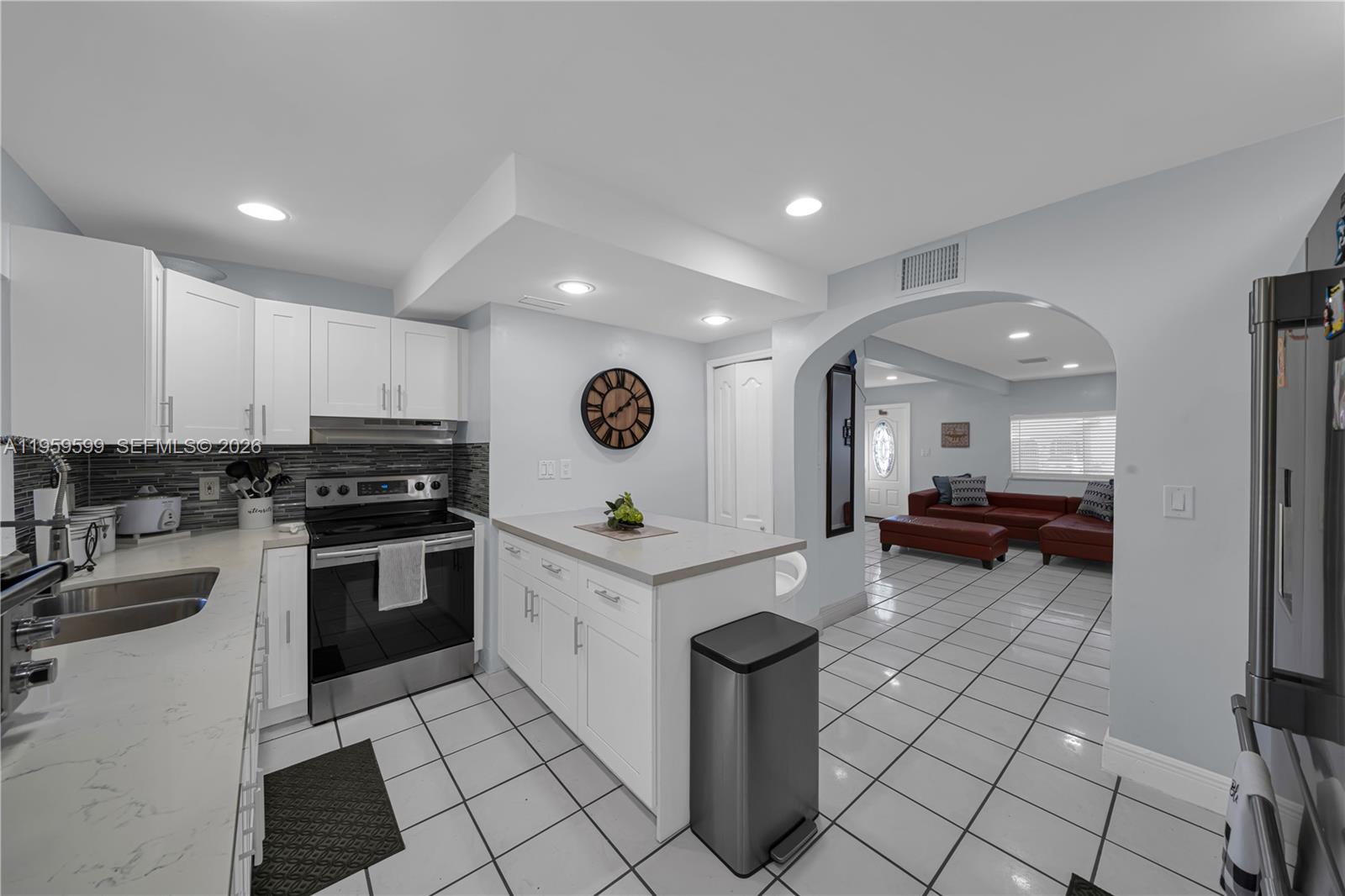 11021 Southwest 4th Street Sweetwater, FL 33174 - Photo 12 of 43 a kitchen with stainless steel appliances kitchen island granite countertop a sink and cabinets