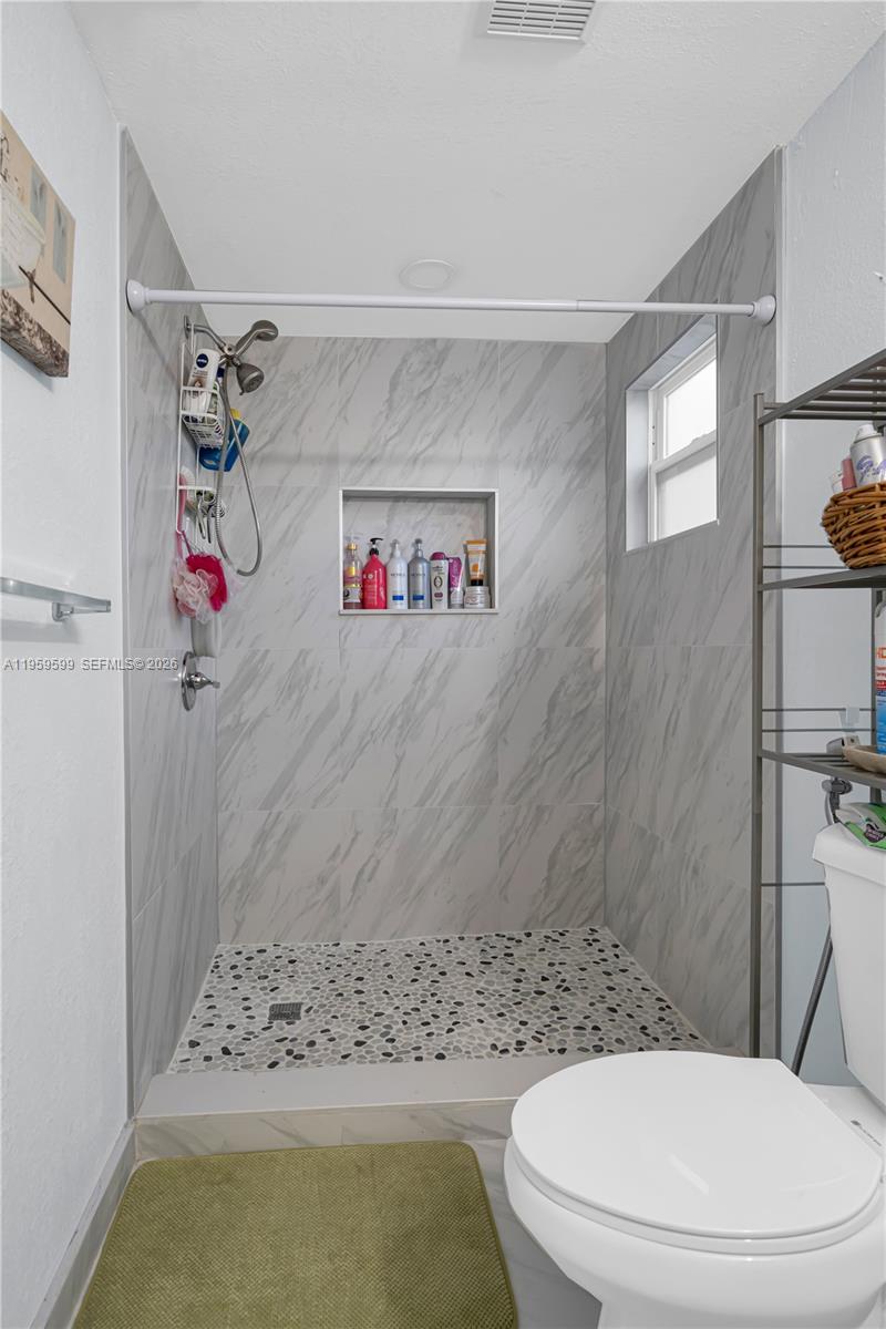 11021 Southwest 4th Street Sweetwater, FL 33174 - Photo 17 of 43 a bathroom with a toilet and a shower