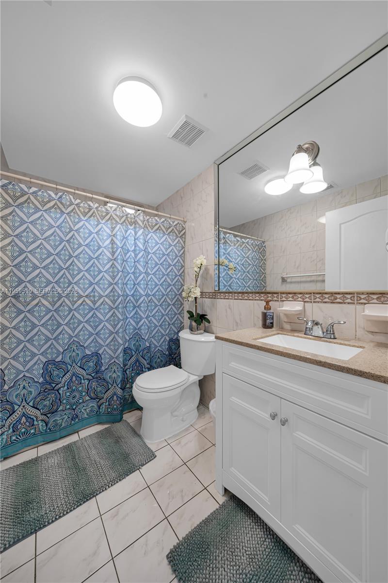 11021 Southwest 4th Street Sweetwater, FL 33174 - Photo 18 of 43 a bathroom with a toilet sink and mirror