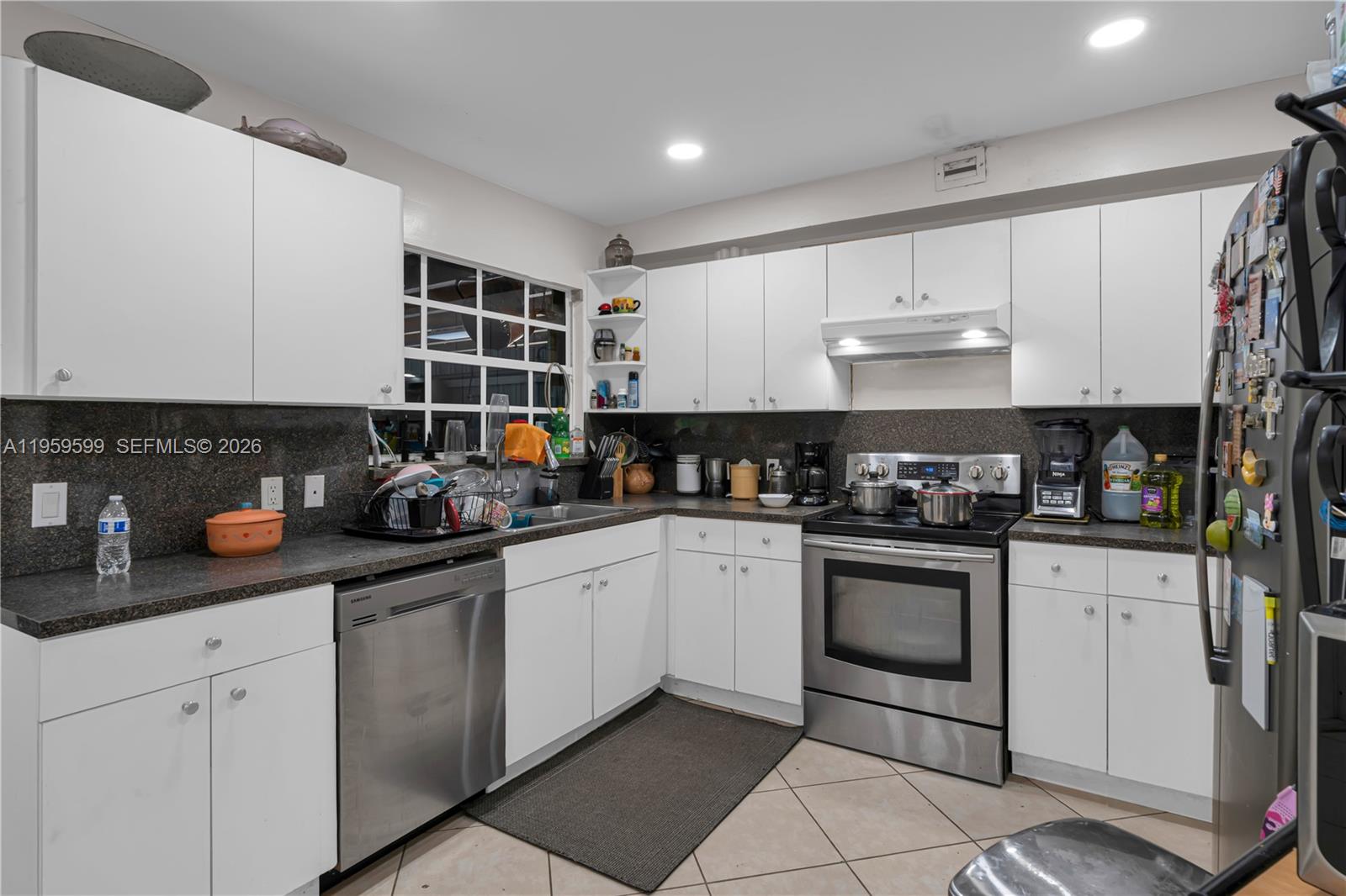11021 Southwest 4th Street Sweetwater, FL 33174 - Photo 32 of 43 a kitchen with stainless steel appliances granite countertop a sink stove and cabinets