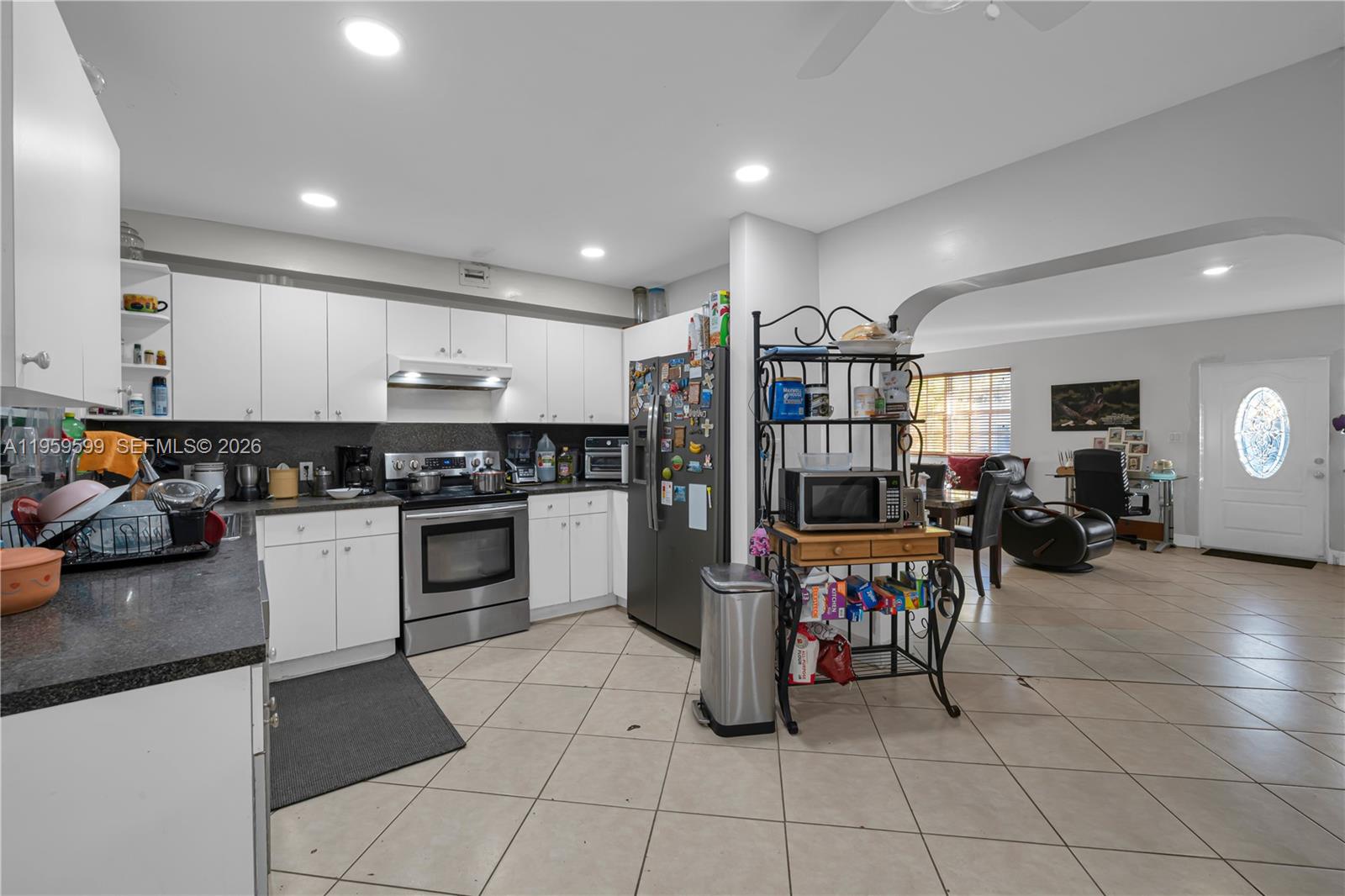 11021 Southwest 4th Street Sweetwater, FL 33174 - Photo 34 of 43 a kitchen with stainless steel appliances granite countertop a refrigerator and a stove top oven