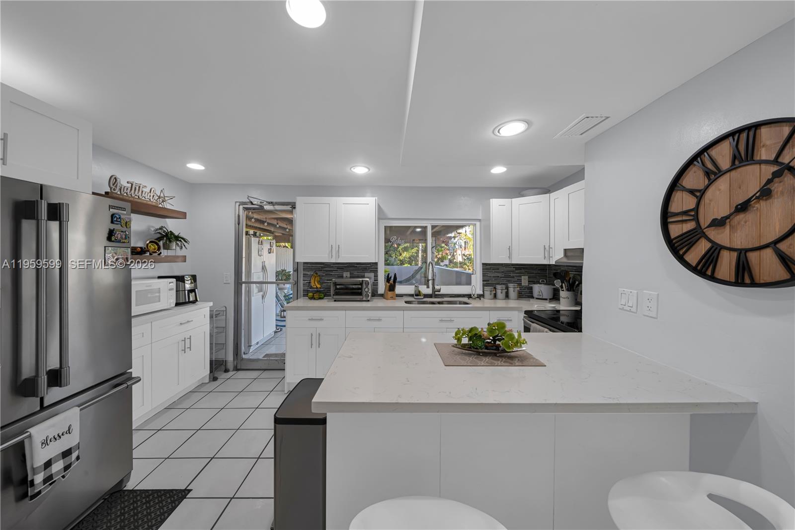 11021 Southwest 4th Street Sweetwater, FL 33174 - Photo 9 of 43 a living room with stainless steel appliances furniture a refrigerator and a kitchen view