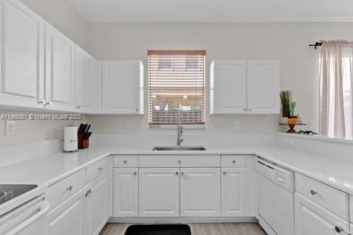 13234 Southwest 128th Path Miami, FL 33186 - Photo 12 of 38 a kitchen with white cabinets and a window
