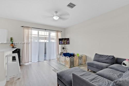 13234 Southwest 128th Path Miami, FL 33186 - Photo 15 of 38 a living room with furniture and a flat screen tv