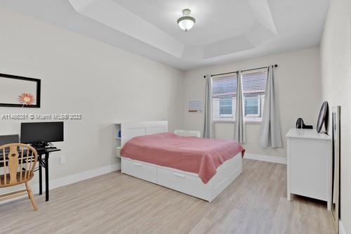 13234 Southwest 128th Path Miami, FL 33186 - Photo 20 of 38 a bedroom with a bed and a flat screen tv