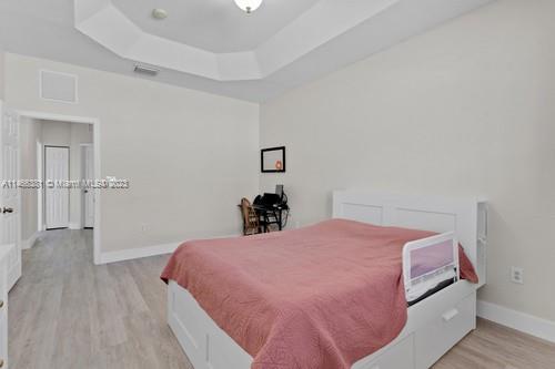 13234 Southwest 128th Path Miami, FL 33186 - Photo 22 of 38 a bed room with a bed and a table