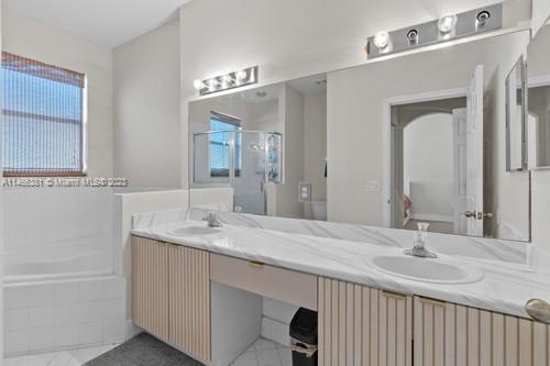 13234 Southwest 128th Path Miami, FL 33186 - Photo 23 of 38 a bathroom with double vanity sinks and a mirror