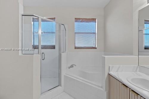 13234 Southwest 128th Path Miami, FL 33186 - Photo 24 of 38 a bathroom with a granite countertop tub sink and mirror