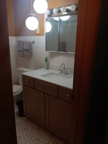 a bathroom with a sink mirror and a window