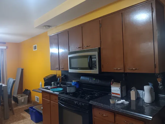 a kitchen with refrigerator and cabinets