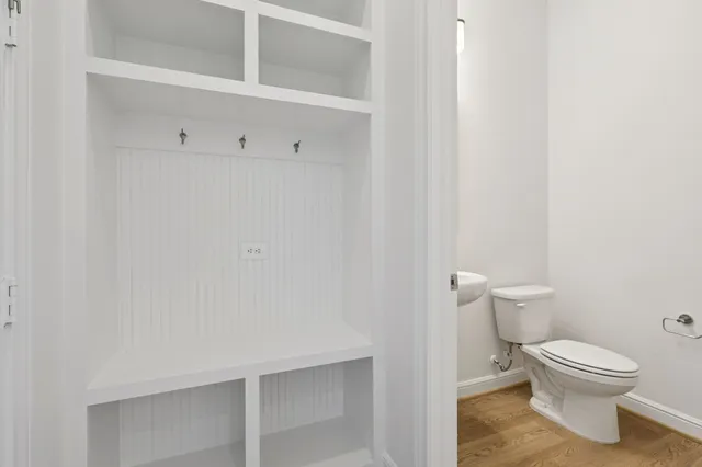 a white toilet sitting next to a shower