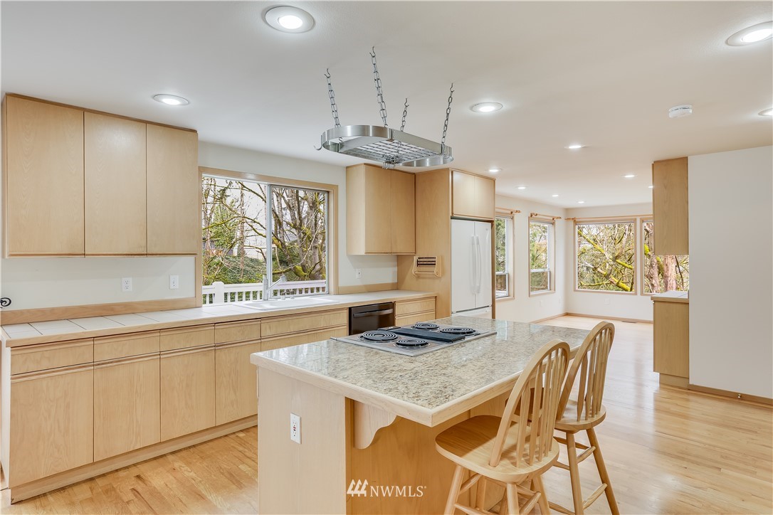 210 Northwest 5th Street Renton, WA 98057 - Photo 13 of 35 a kitchen with stainless steel appliances granite countertop a kitchen island a stove a cabinets a sink and a dining table