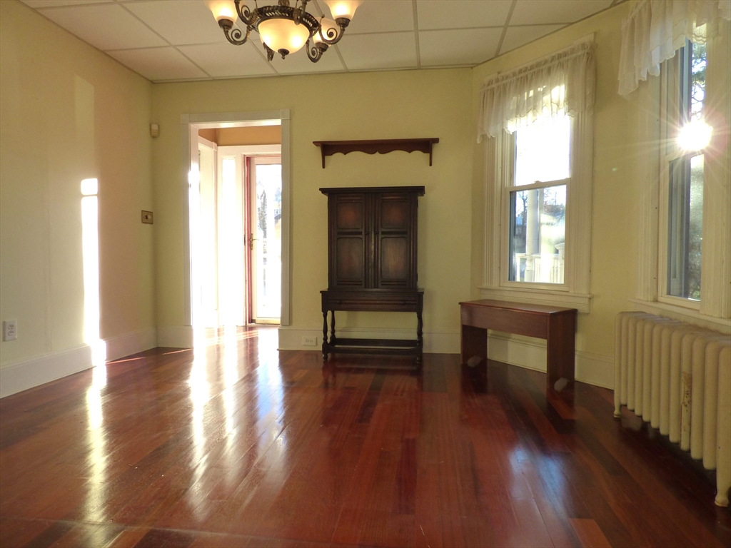 298 Main Street Springfield, MA 01151 - Photo 15 of 40 a view of an empty room with wooden floor and a window