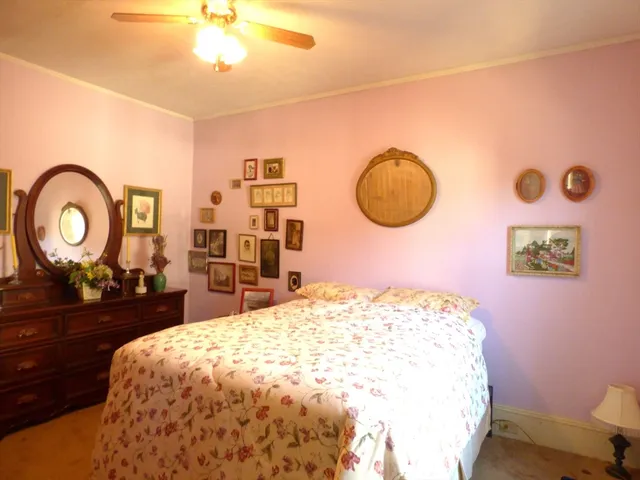 a bedroom with a bed and a dresser