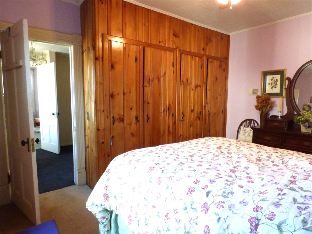 298 Main Street Springfield, MA 01151 - Photo 20 of 40 a bedroom with a bed and a dresser