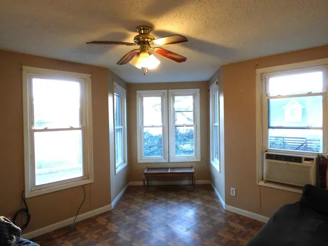a view of a room with wooden floor and windows