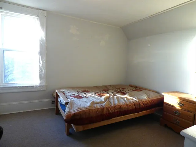 a bedroom with a bed and a mirror
