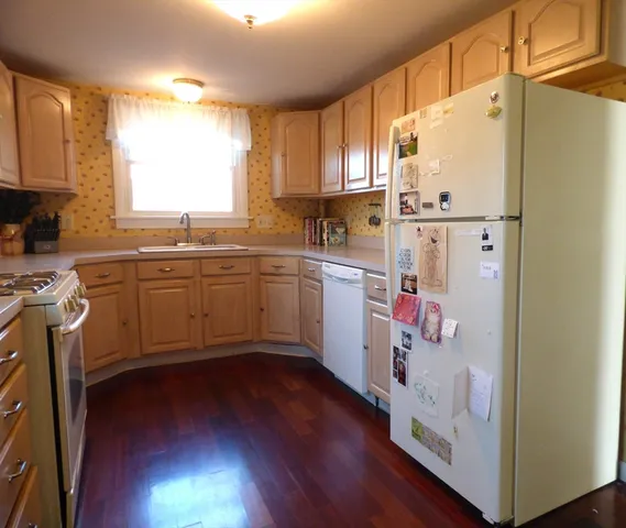 a kitchen with cabinets a sink and appliances
