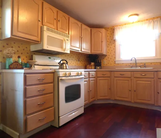 a kitchen with a stove oven and sink