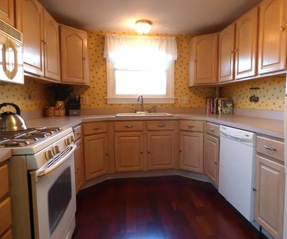 a kitchen with a sink stove and cabinets