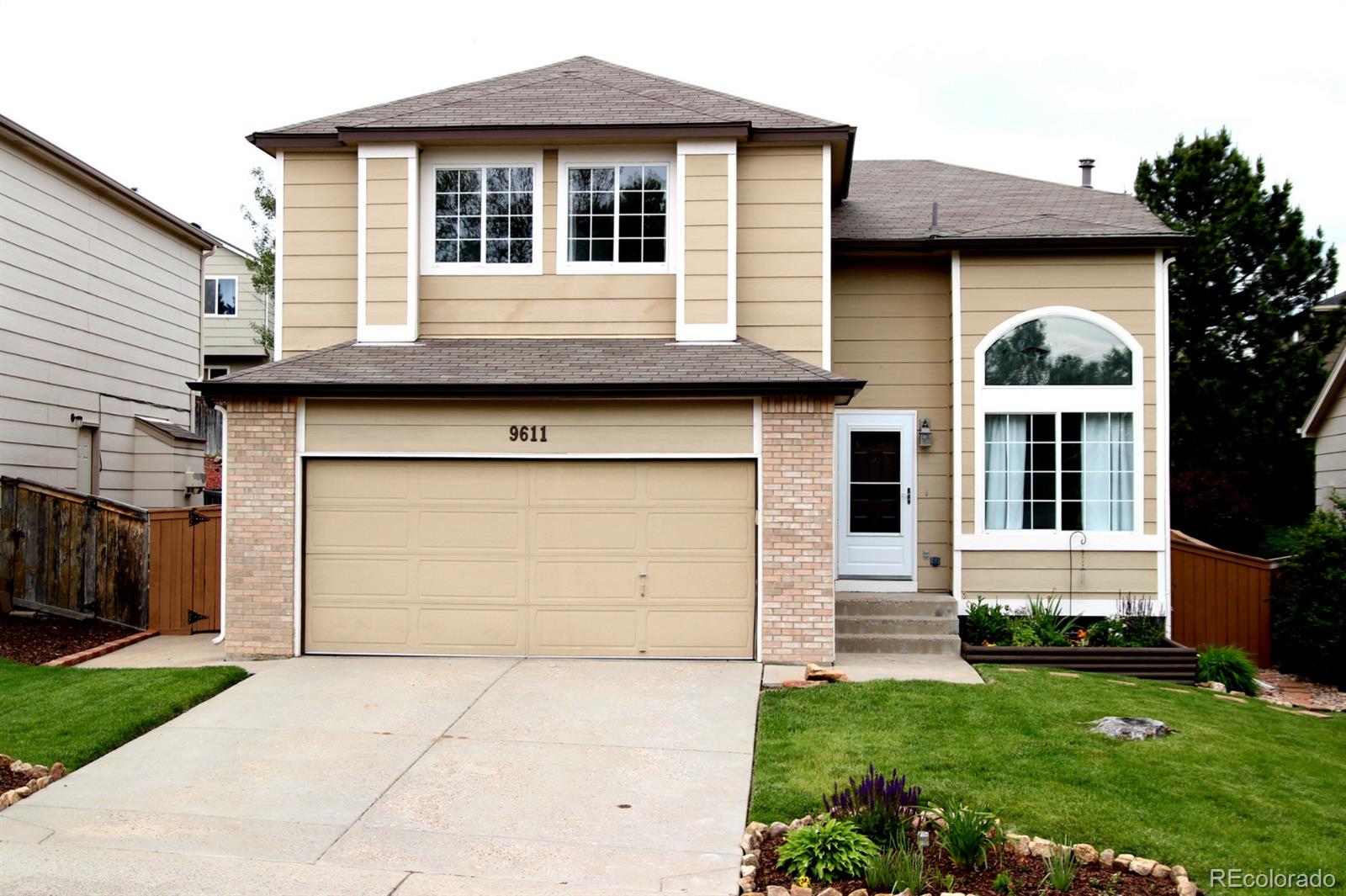 a front view of a house with garden