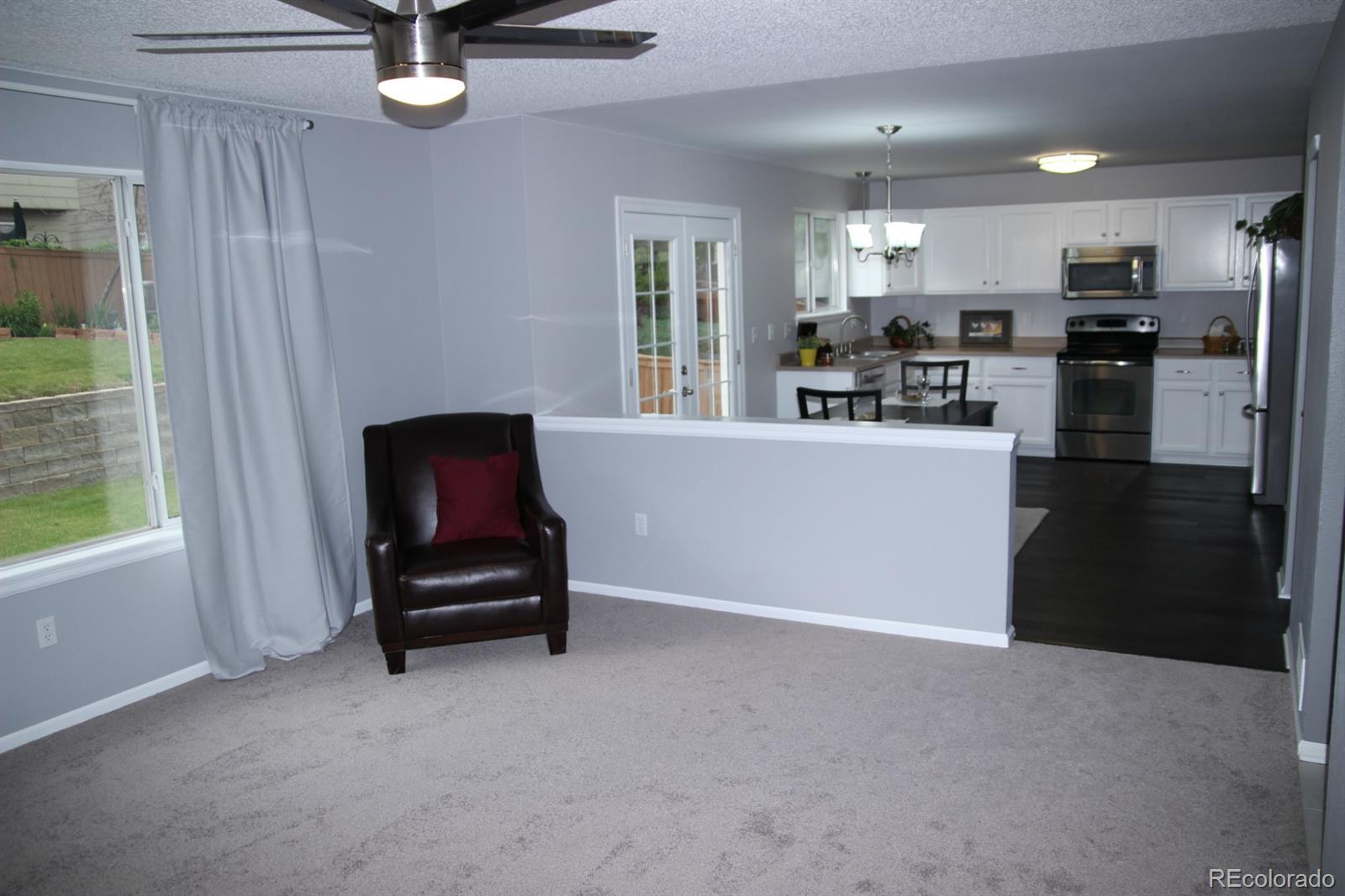 9611 South Castle Ridge Circle Highlands Ranch, CO 80129 - Photo 11 of 25 a living room with furniture and a flat screen tv