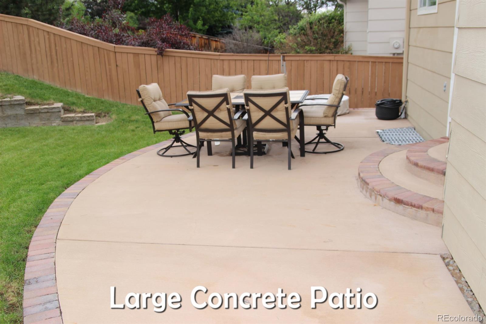 9611 South Castle Ridge Circle Highlands Ranch, CO 80129 - Photo 25 of 25 a view of a chairs and table in the back yard
