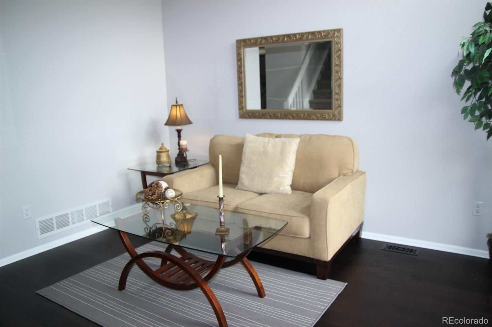 9611 South Castle Ridge Circle Highlands Ranch, CO 80129 - Photo 5 of 25 a living room with furniture and wooden floor