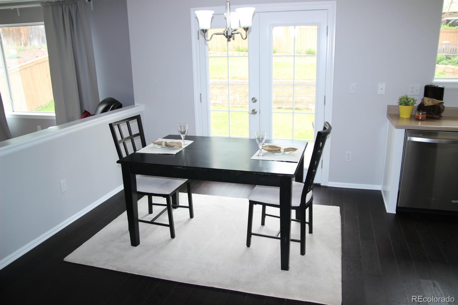 9611 South Castle Ridge Circle Highlands Ranch, CO 80129 - Photo 8 of 25 a view of a dining room with furniture and window