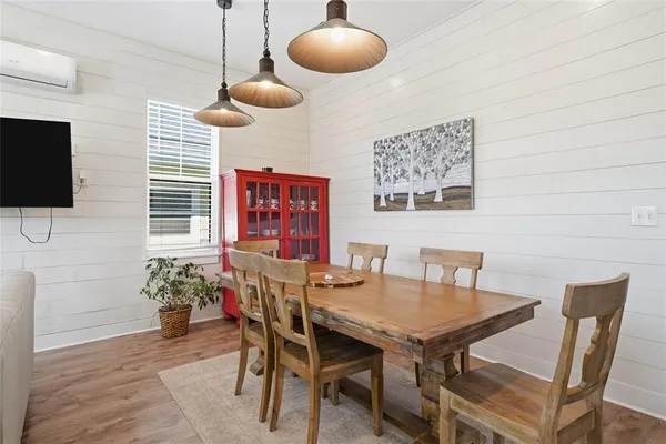 a view of a dining room with furniture and wooden floor