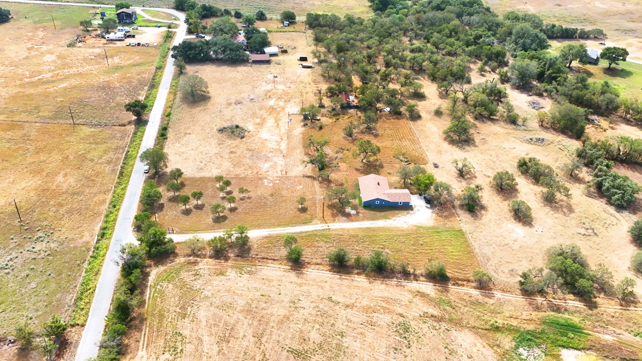311 Salt Lake Road Luling, TX 78648 - Photo 32 of 37 An aerial perspective captures the vast rural acreage surrounding the central home.