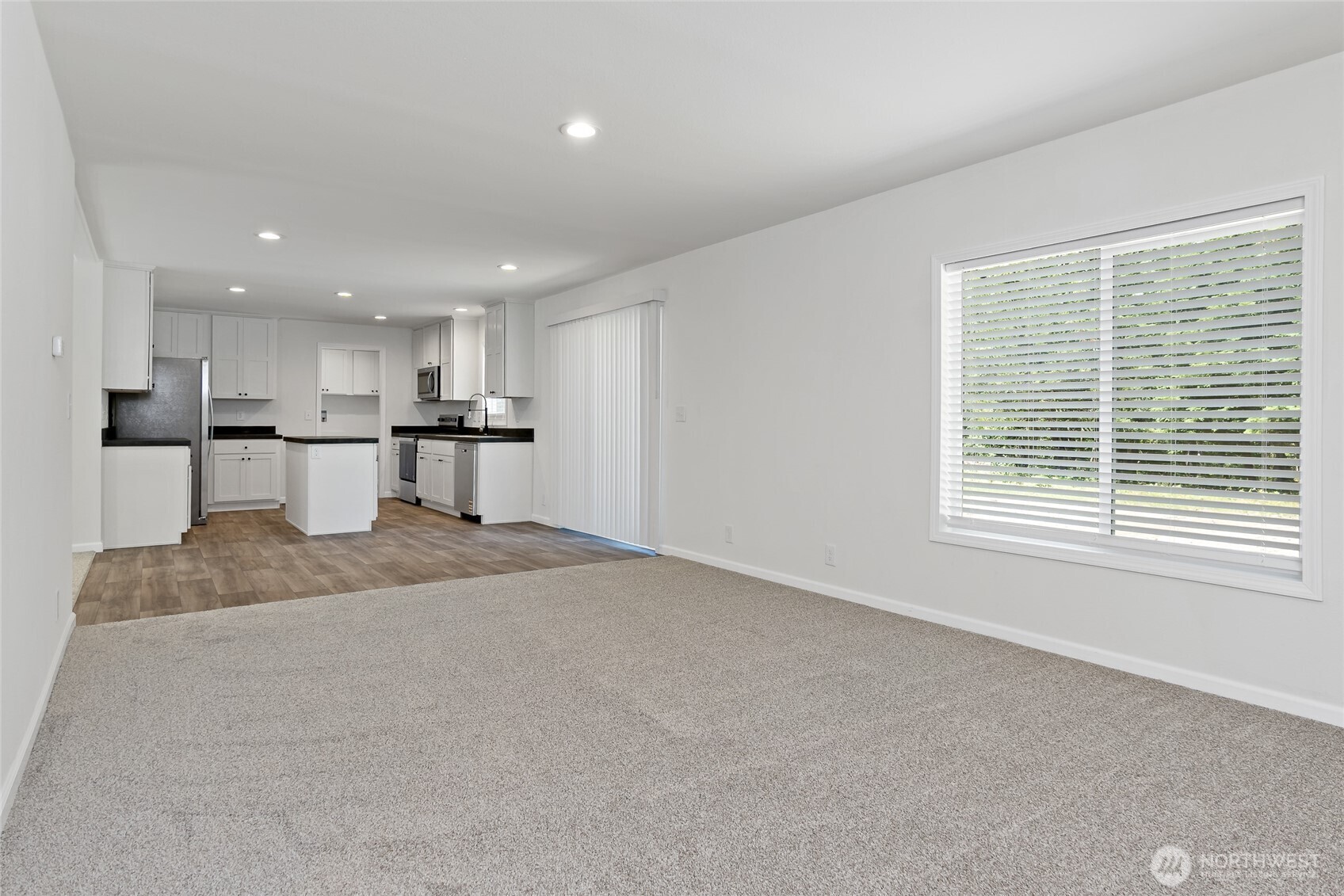 17217 80th Street Southwest Longbranch, WA 98351 - Photo 17 of 39 a large kitchen with kitchen island a sink wooden floor and a window