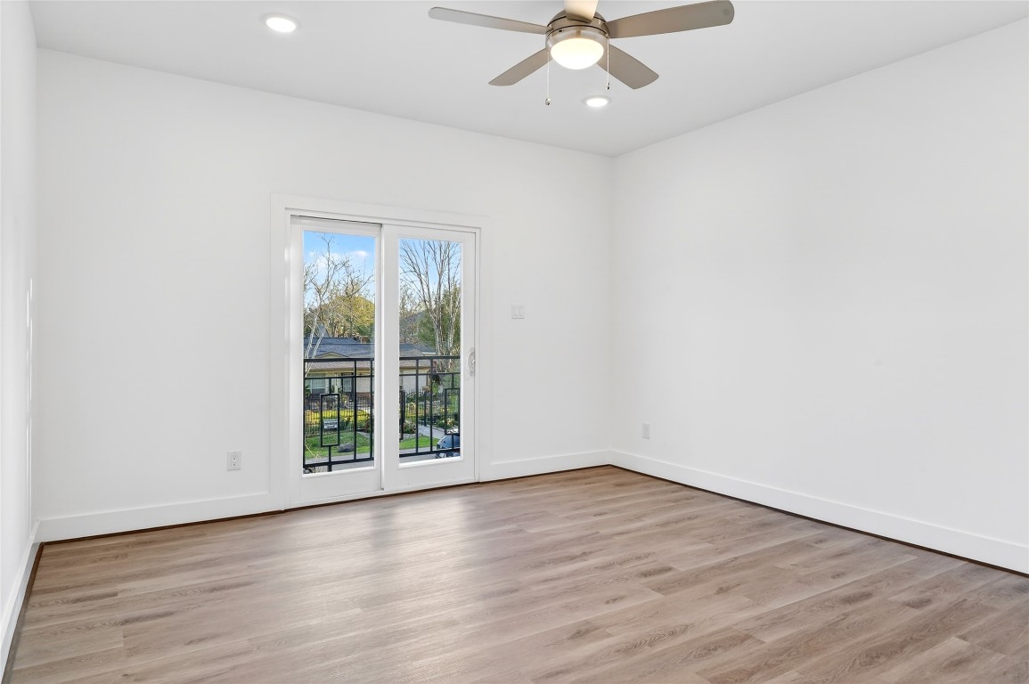 10232 Porto Rico Road Houston, TX 77041 - Photo 15 of 30 an empty room with wooden floor and windows