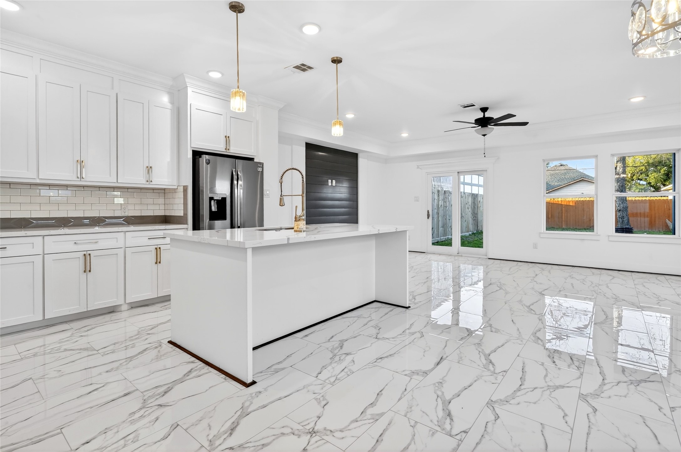 10232 Porto Rico Road Houston, TX 77041 - Photo 8 of 30 a kitchen with stainless steel appliances kitchen island granite countertop a refrigerator a stove a sink and white cabinets with wooden floor