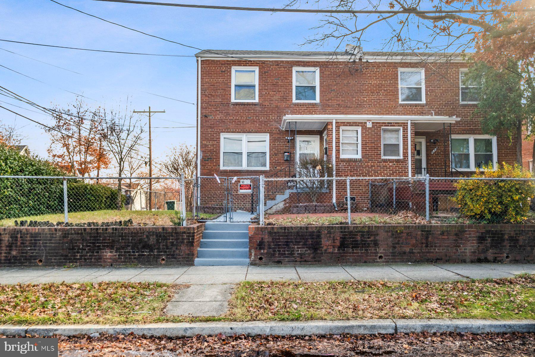 883 Bellevue Street Southeast, Unit 2 Washington, DC 20032 - Photo 1 of 37 a front view of a house with a yard