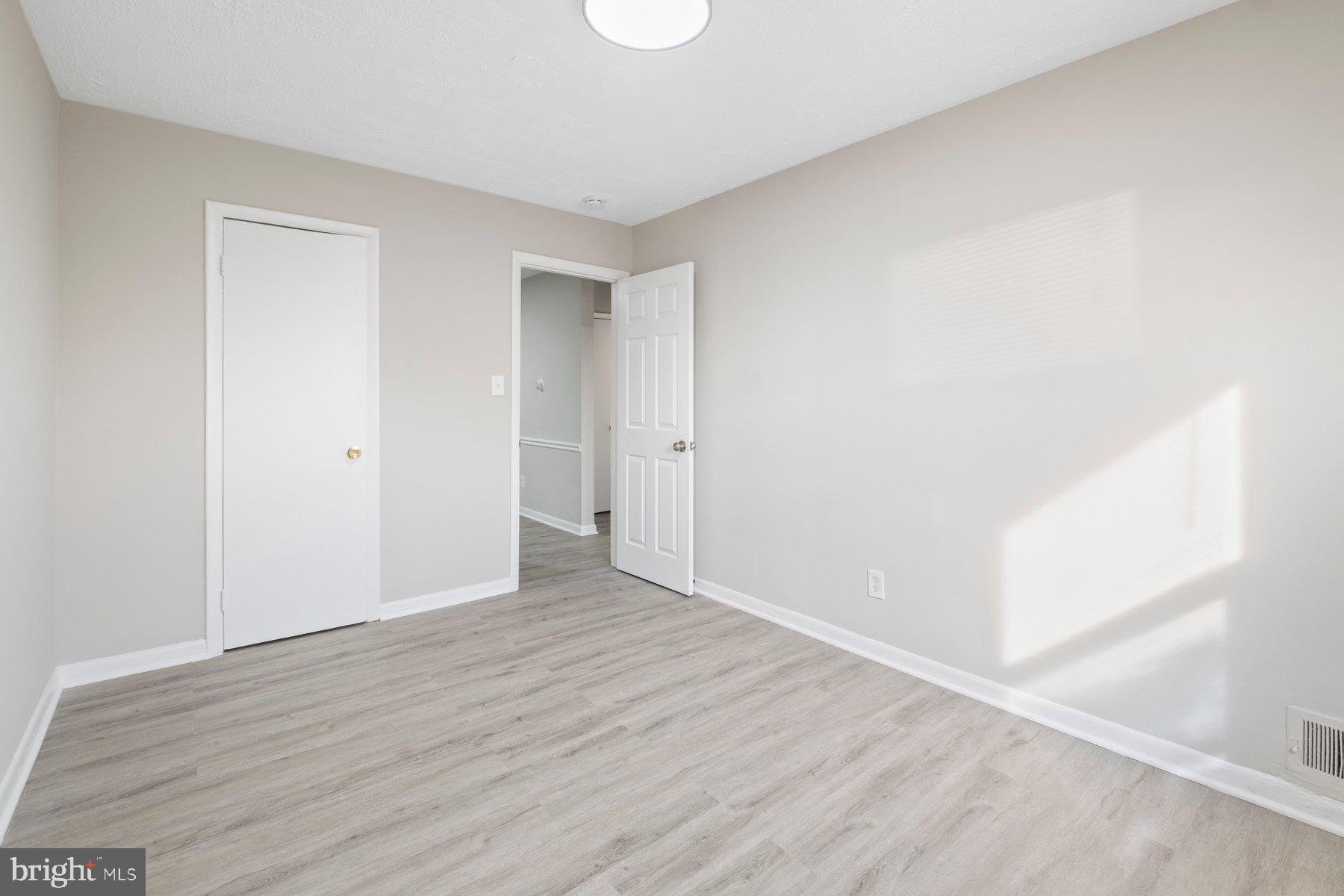 883 Bellevue Street Southeast, Unit 2 Washington, DC 20032 - Photo 13 of 37 a view of an empty room with wooden floor