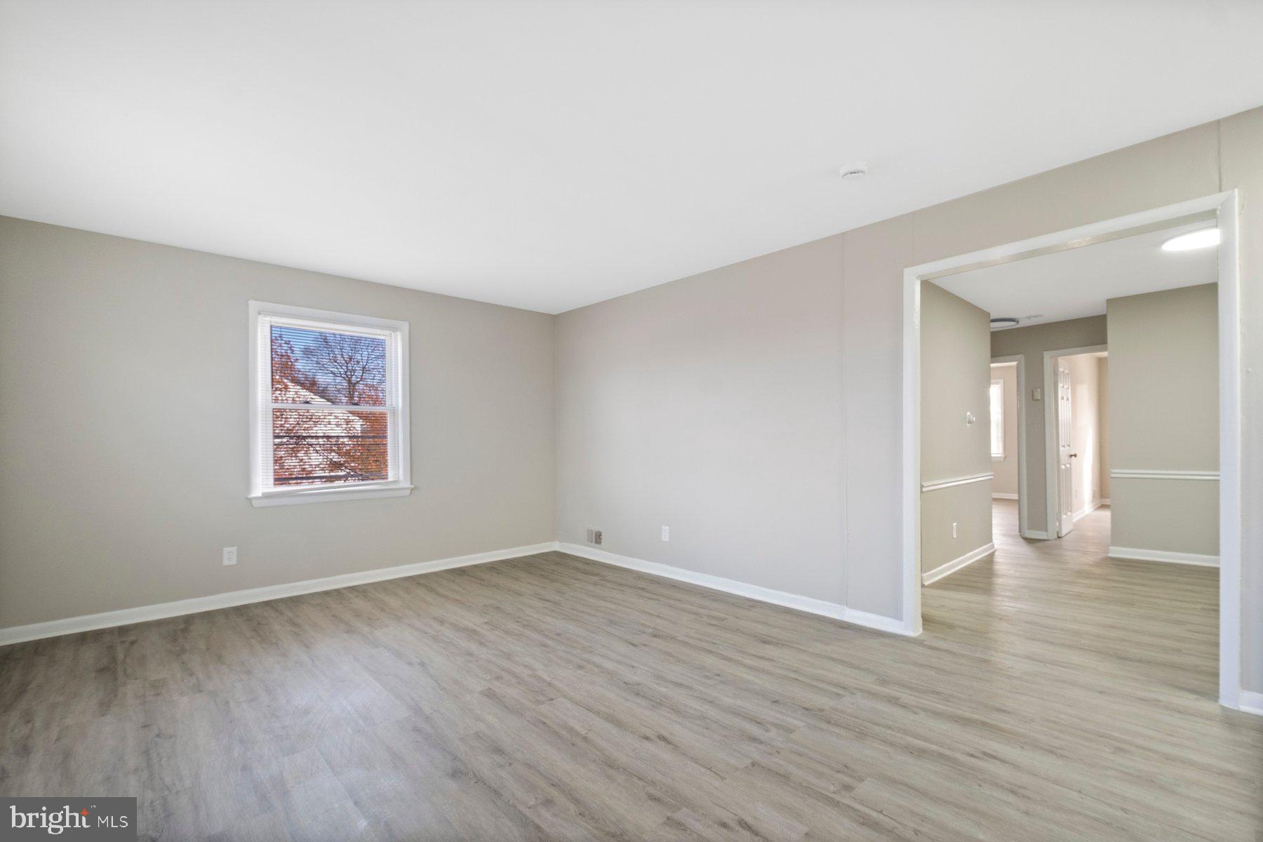 883 Bellevue Street Southeast, Unit 2 Washington, DC 20032 - Photo 17 of 37 a view of an empty room with wooden floor