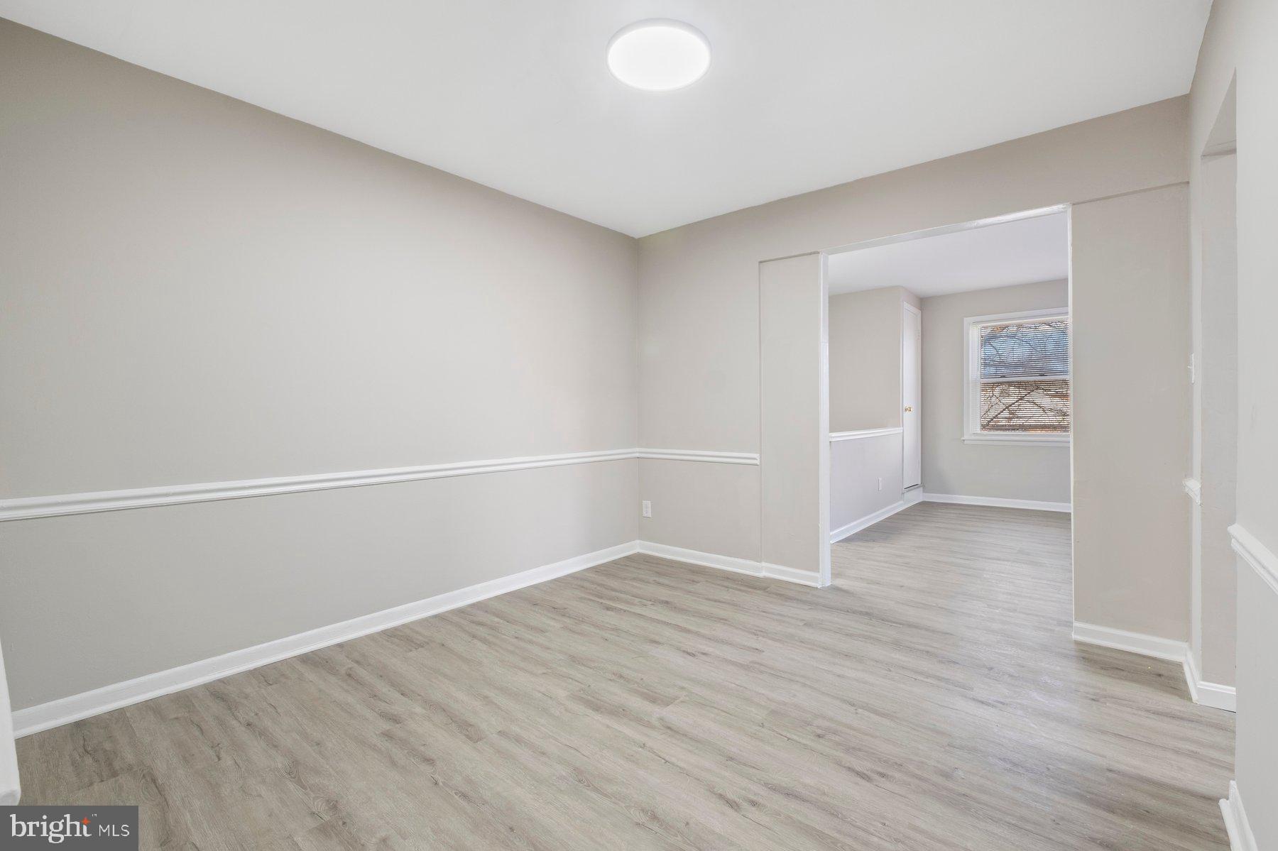 883 Bellevue Street Southeast, Unit 2 Washington, DC 20032 - Photo 18 of 37 wooden floor in an empty room