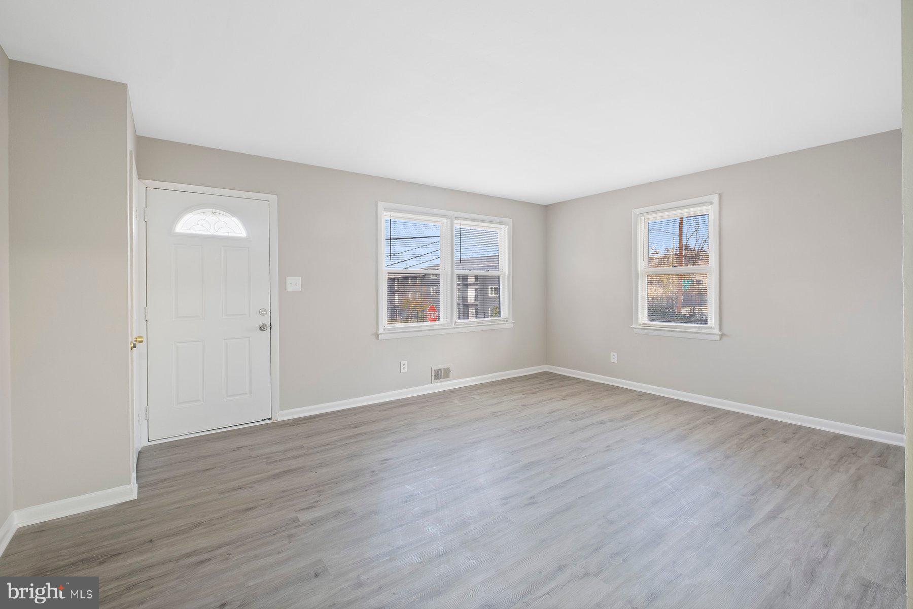 883 Bellevue Street Southeast, Unit 2 Washington, DC 20032 - Photo 21 of 37 a view of an empty room with window and wooden floor