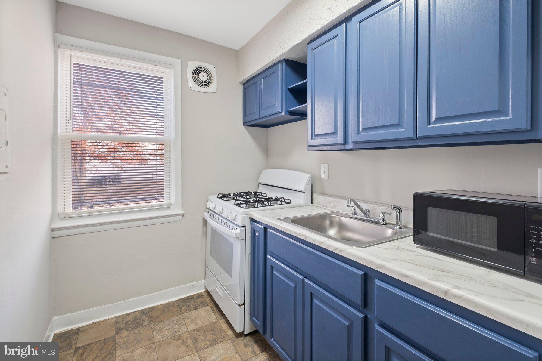 883 Bellevue Street Southeast, Unit 2 Washington, DC 20032 - Photo 25 of 37 a kitchen with granite countertop cabinets stainless steel appliances and a sink