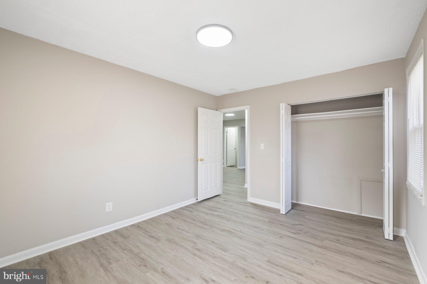 883 Bellevue Street Southeast, Unit 2 Washington, DC 20032 - Photo 29 of 37 a view of an empty room with wooden floor