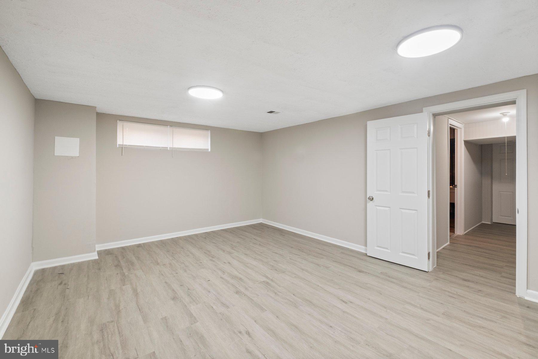 883 Bellevue Street Southeast, Unit 2 Washington, DC 20032 - Photo 32 of 37 a view of an empty room with wooden floor