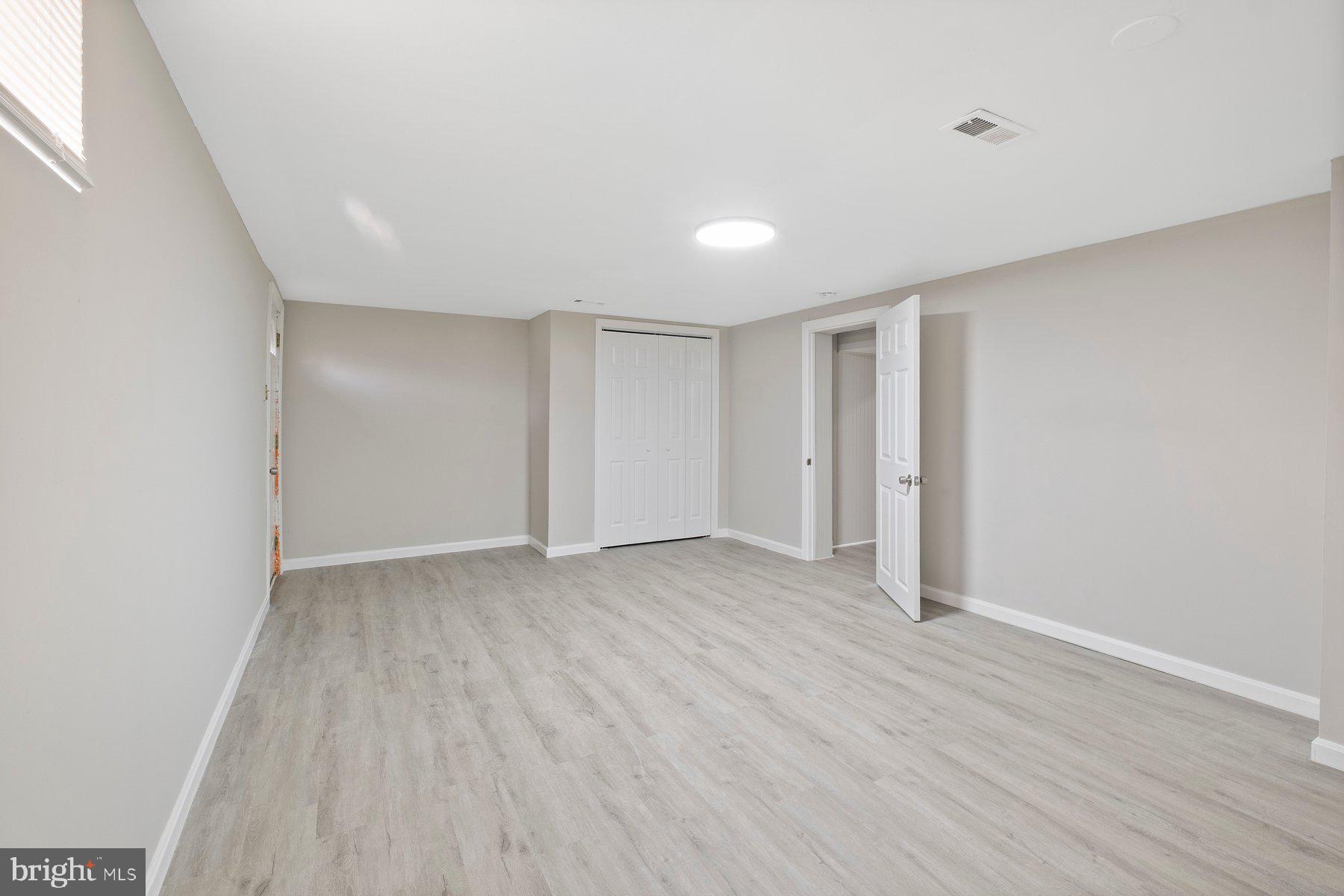 883 Bellevue Street Southeast, Unit 2 Washington, DC 20032 - Photo 34 of 37 a view of an empty room with wooden floor