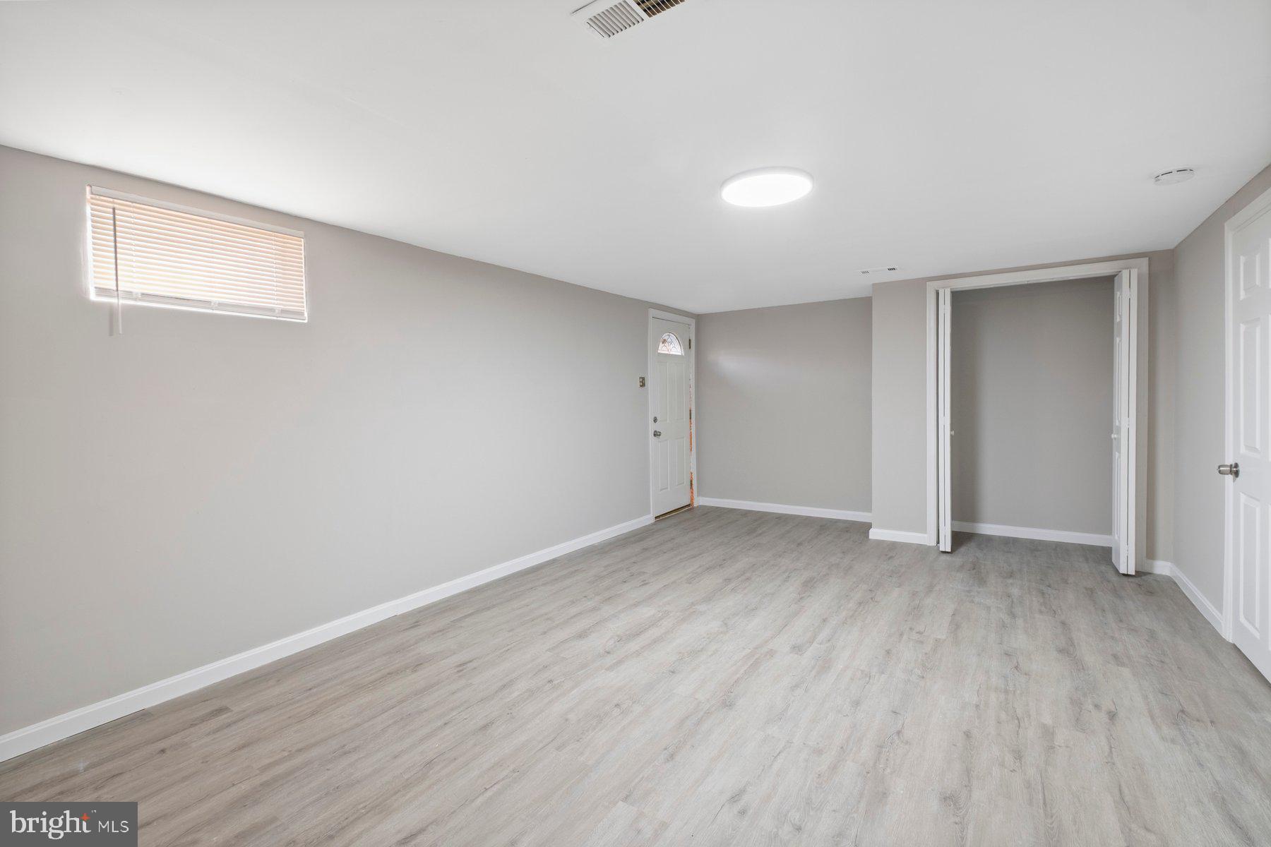 883 Bellevue Street Southeast, Unit 2 Washington, DC 20032 - Photo 35 of 37 a view of an empty room with wooden floor