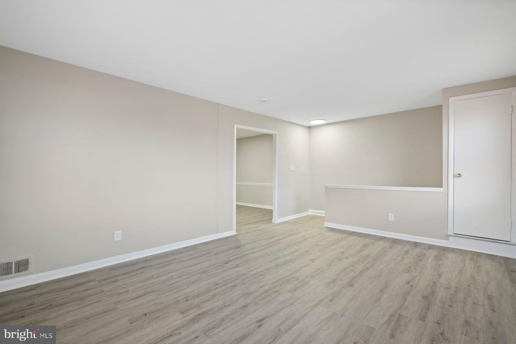 883 Bellevue Street Southeast, Unit 2 Washington, DC 20032 - Photo 7 of 37 a view of an empty room with wooden floor