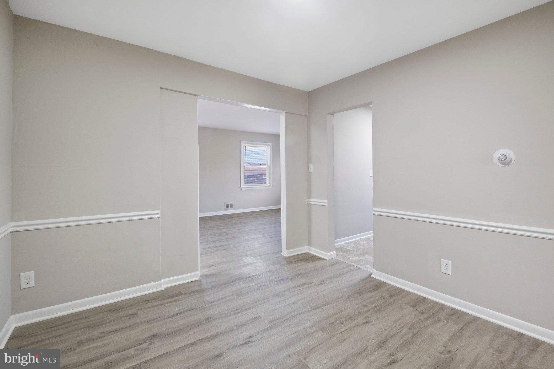 883 Bellevue Street Southeast, Unit 2 Washington, DC 20032 - Photo 9 of 37 a view of an empty room with wooden floor