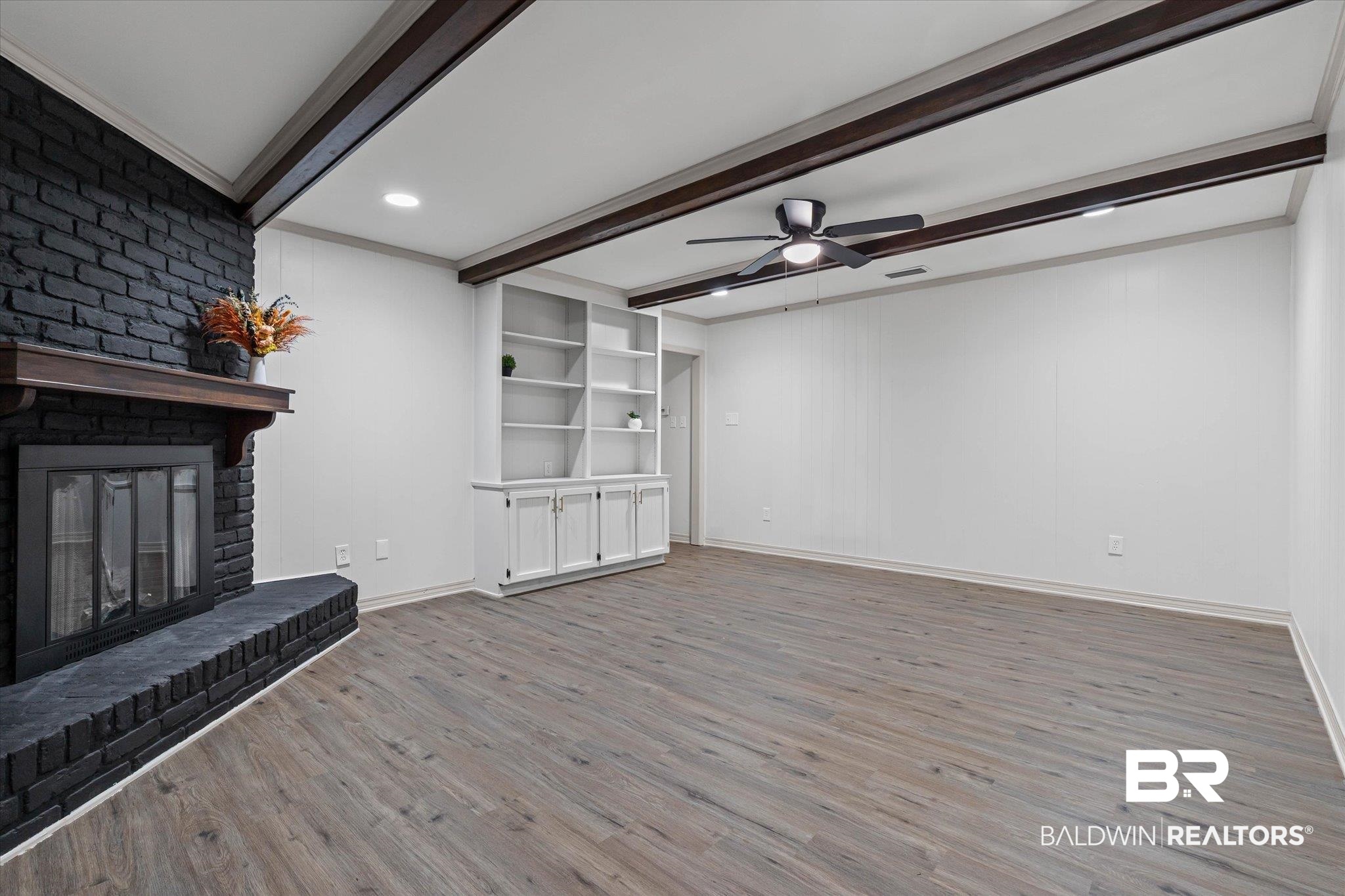 3655 Claridge Road South Mobile, AL 36608 - Photo 9 of 32 Unfurnished living room with beam ceiling, wood finished floors, a ceiling fan, and a fireplace