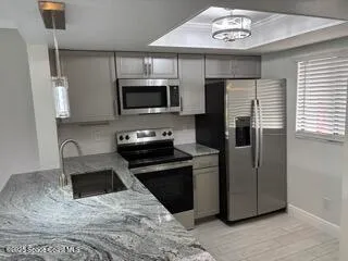 a kitchen with a refrigerator stove and microwave