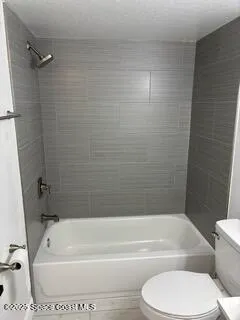 a bathroom with a toilet and a tub